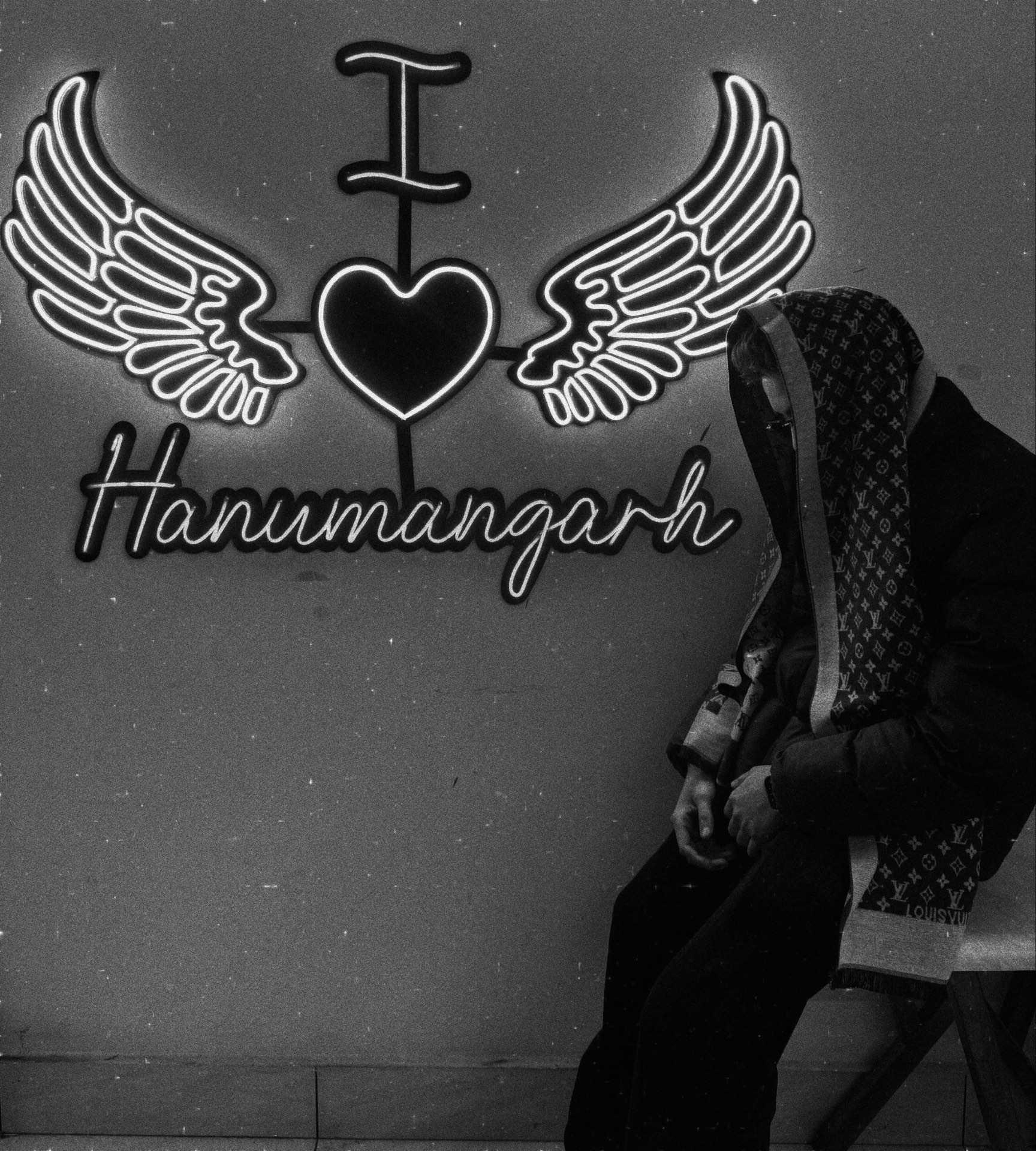 Manthan Kumar Sharma in front of an I love Hanumangarh neon sign