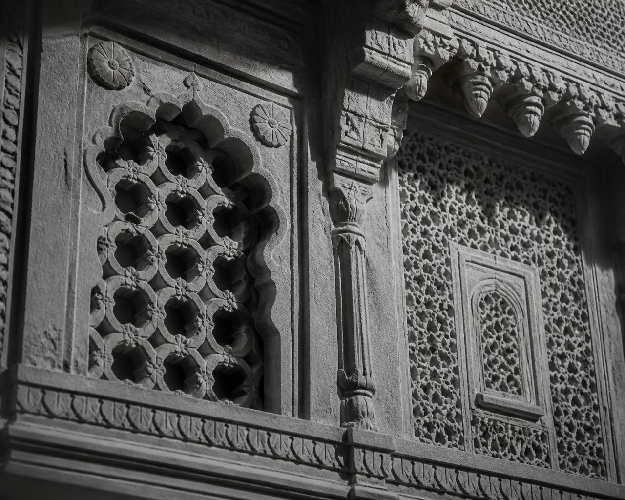Carved sandstone jali work on a haveli wall